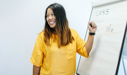 Colleague writing on a whiteboard