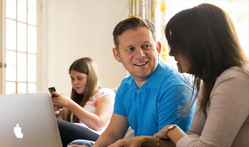 family looking at laptop