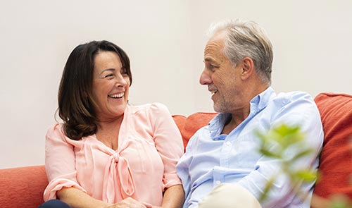 Laughing couple on sofa