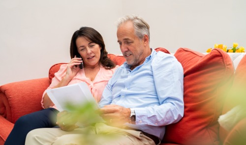 couple on sofa on phone