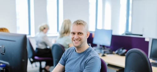 a debt advisor listening to a call through a headset