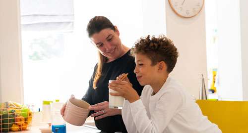 mum and son smiling in kitchen