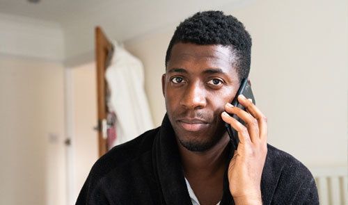 man on phone looking worried