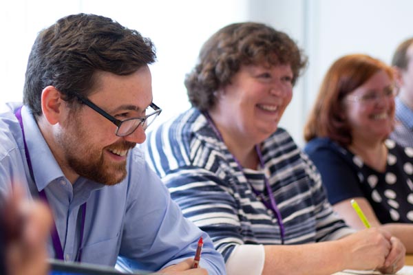 colleagues laughing in meeting