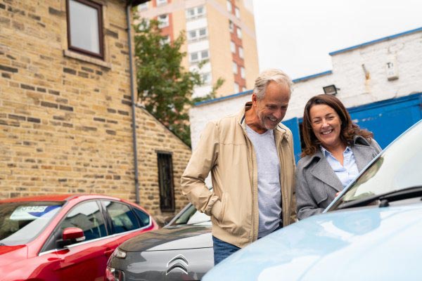 Smiling couple car shopping