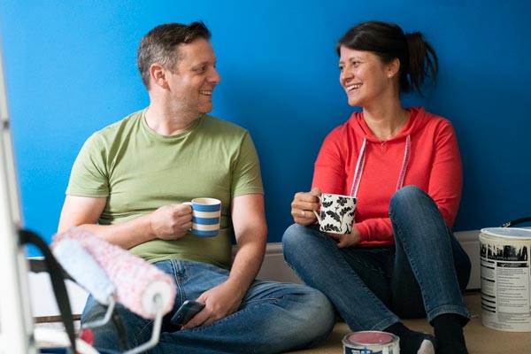 couple drinking tea and painting a room