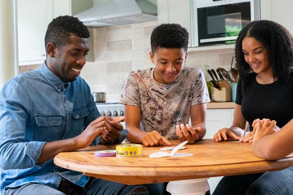 Family playing games at the kitchen table