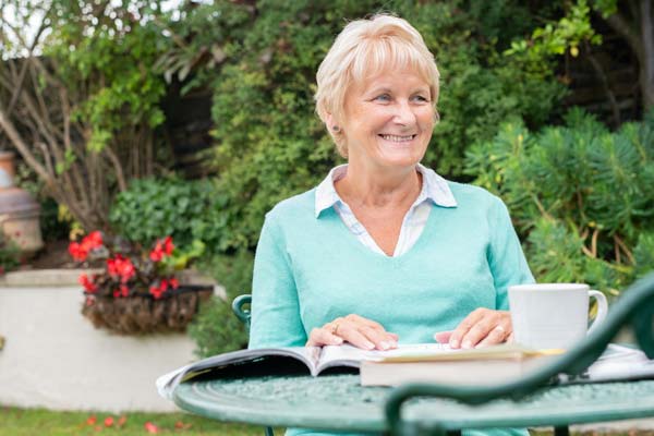 A woman sitting in her garden