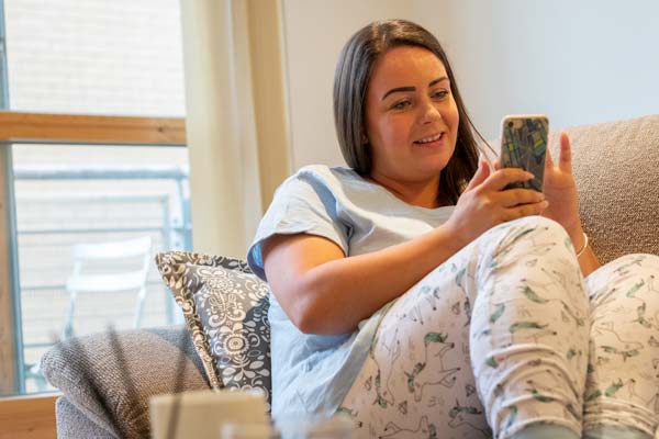 woman on sofa with phone