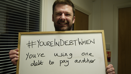 colleague taking part in Debt Awareness Week 2014