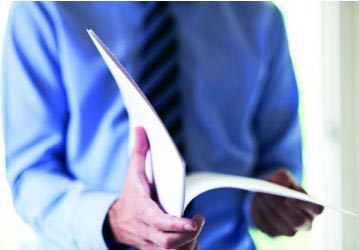 Man flicking through reports