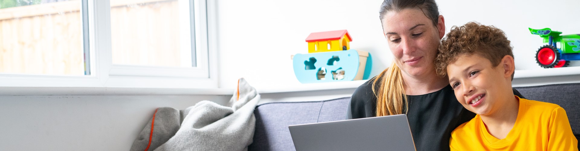 Woman looking at laptop with her son