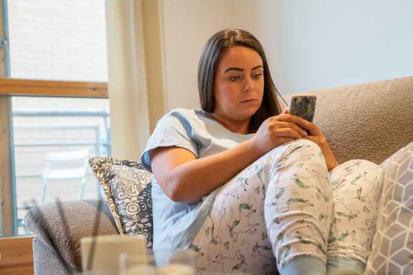 woman in her pjs on the sofa