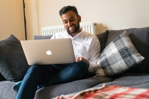 man on sofa with laptop