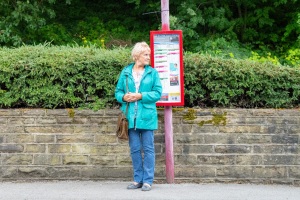 woman waiting at bus stop