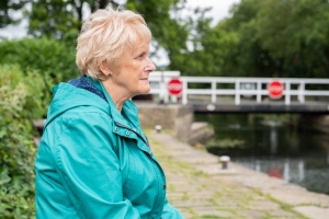 woman sat next to a canal