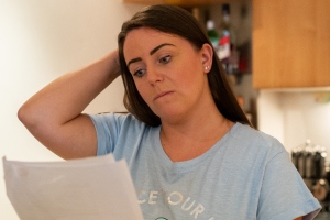 worried woman reading paperwork