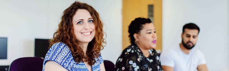 colleagues smiling in meeting room